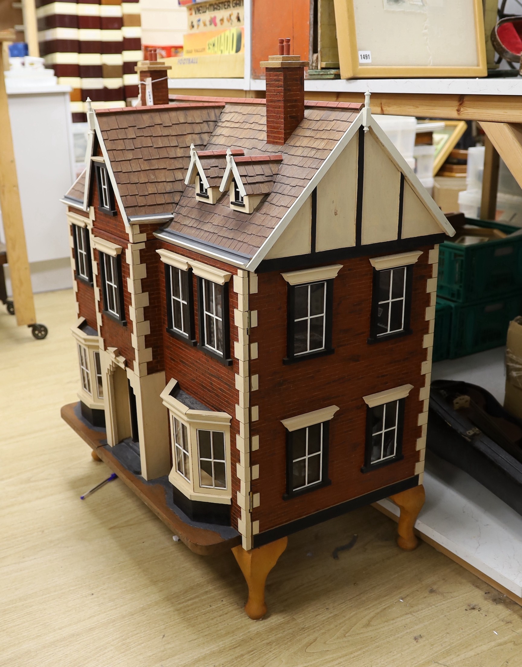 A mid 20th century doll's house and contents, 84cms x 100cms high